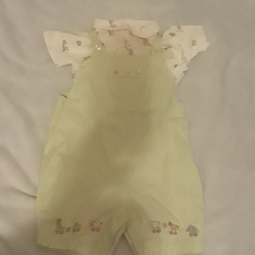 Pale green jumpsuit, cream colored polo